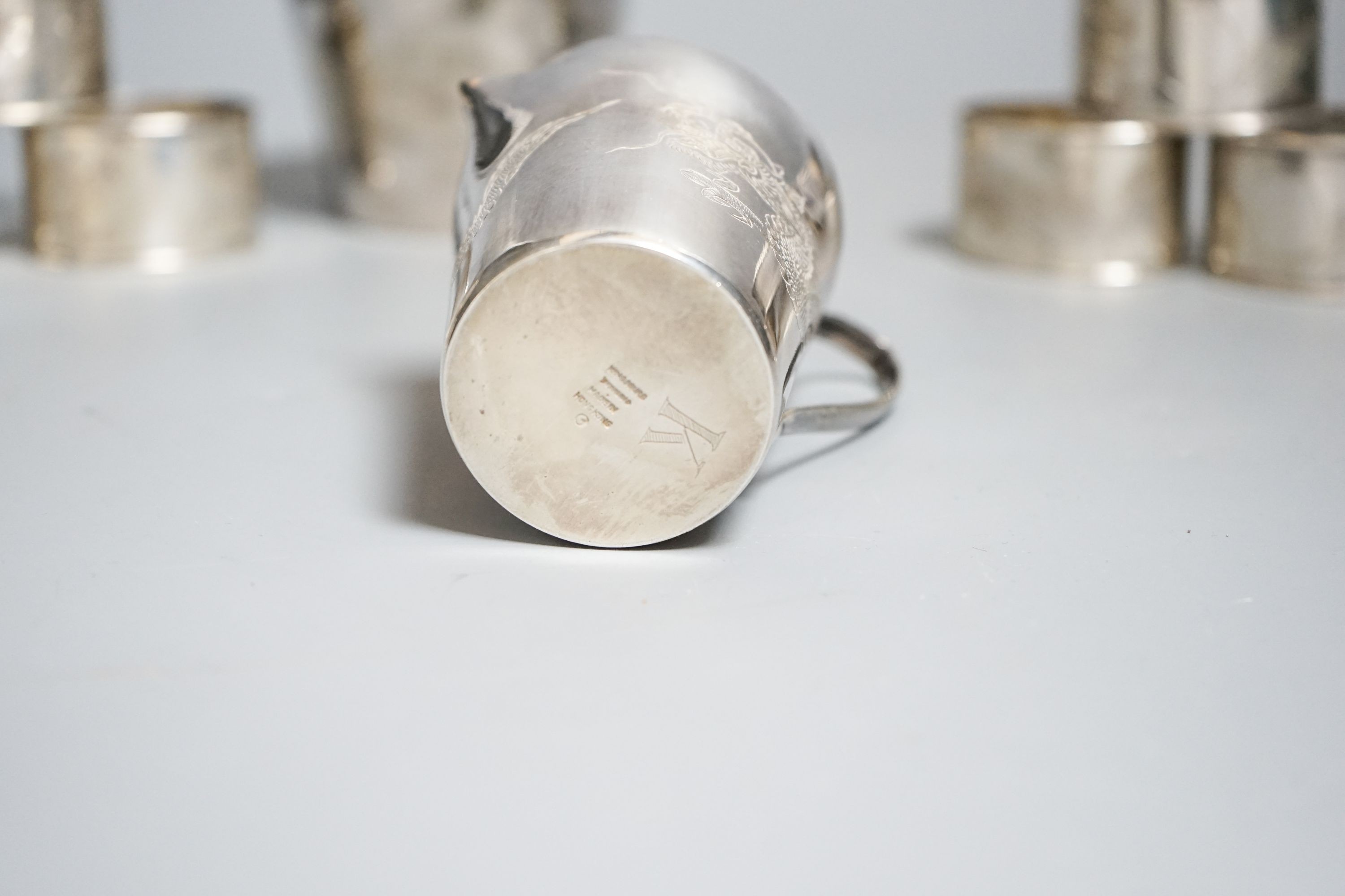 A Chinese sterling pot and cover by Kingsburg, Hong Kong, 9.4cm, a similar cream jug and six napkin rings by Wang Hing